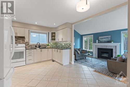 65 Hawley Crescent, Kanata (9004 - Kanata - Bridlewood), ON - Indoor Photo Showing Kitchen With Fireplace