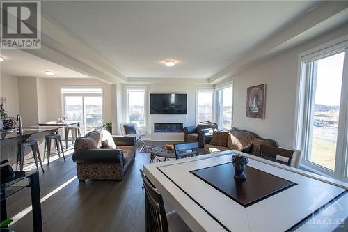 Dining Room/ Living Room - 659 Fenwick Way, Ottawa, ON - Indoor Photo Showing Living Room With Fireplace