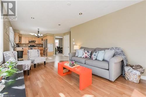 Living room with light hardwood / wood-style floors and an inviting chandelier - 613 Black Street, Fergus, ON - Indoor Photo Showing Living Room