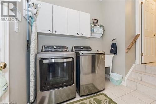 Washroom with separate washer and dryer, light tile patterned flooring, and cabinets - 613 Black Street, Fergus, ON - Indoor Photo Showing Laundry Room