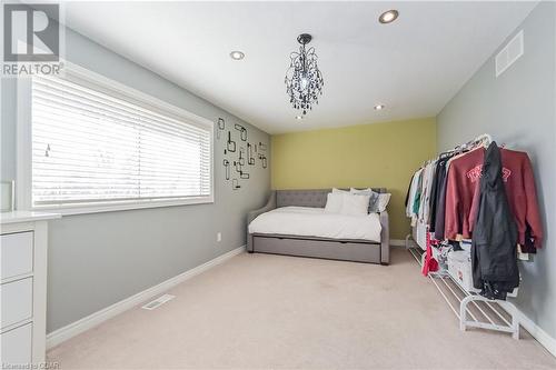 Carpeted bedroom with a notable chandelier - 613 Black Street, Fergus, ON - Indoor