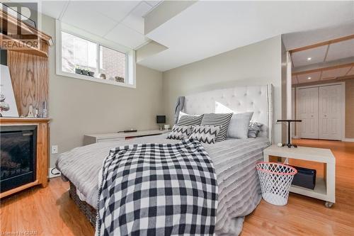 Bedroom featuring a fireplace and light hardwood / wood-style floors - 613 Black Street, Fergus, ON - Indoor Photo Showing Bedroom