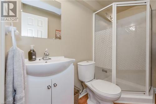 Bathroom featuring vanity, hardwood / wood-style flooring, toilet, and a shower with door - 613 Black Street, Fergus, ON - Indoor Photo Showing Bathroom