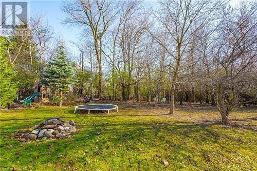 View of yard with a playground, an outdoor fire pit, and a trampoline - 613 Black Street, Fergus, ON - Outdoor