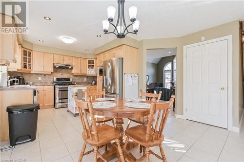 Tiled dining room with sink and a notable chandelier - 613 Black Street, Fergus, ON - Indoor