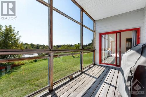 Main floor third bedroom patio doors to screened porch - 9868 County Road 42 Road, Westport, ON - Outdoor With Exterior