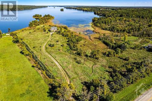 Home set well back from township road for peaceful privacy - 9868 County Road 42 Road, Westport, ON - Outdoor With Body Of Water With View