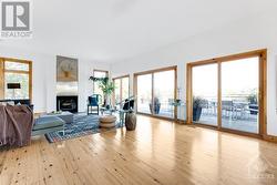 Living-dining area wood-burning fireplace and wall of windows - 