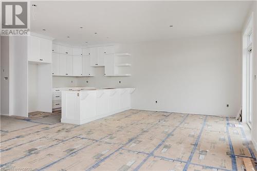 Kitchen with white cabinets, plenty of natural light, a kitchen island, and a breakfast bar area - Lot 16 Mclean Crescent, Port Elgin, ON - Indoor Photo Showing Other Room