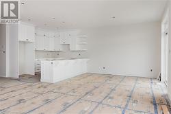 Kitchen with white cabinets, plenty of natural light, a kitchen island, and a breakfast bar area - 