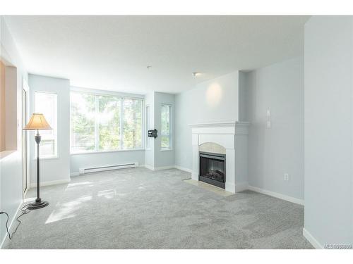 207-5660 Edgewater Lane, Nanaimo, BC - Indoor Photo Showing Living Room With Fireplace