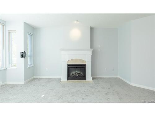 207-5660 Edgewater Lane, Nanaimo, BC - Indoor Photo Showing Living Room With Fireplace