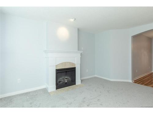 207-5660 Edgewater Lane, Nanaimo, BC - Indoor Photo Showing Living Room With Fireplace