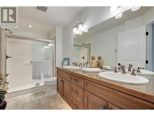 Primary ensuite - dual vanities, granite tile counters and cabinet underlighting. - 2770 Auburn Road Unit# 201, West Kelowna, BC - Indoor Photo Showing Bathroom