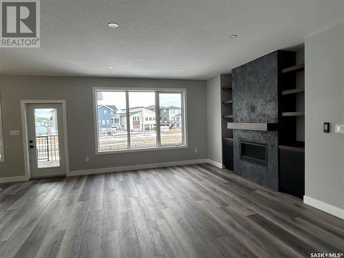 5218 E Green Crescent, Regina, SK - Indoor Photo Showing Living Room With Fireplace