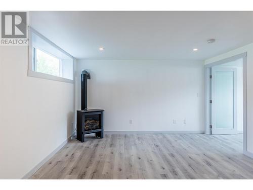 Cozy gas fireplace and vinyl plank flooring throughout - 3600 13 Street, Vernon, BC 