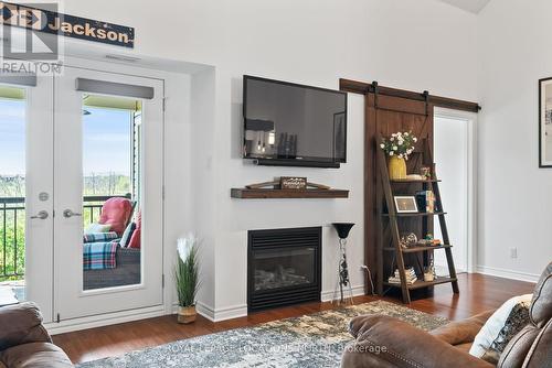 302 - 10 Brandy Lane Drive, Collingwood, ON - Indoor Photo Showing Living Room With Fireplace