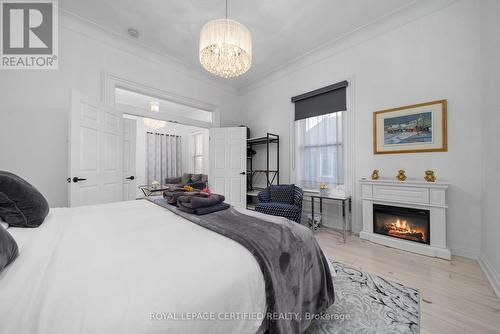 125 Picton Main Street, Prince Edward County, ON - Indoor Photo Showing Bedroom With Fireplace