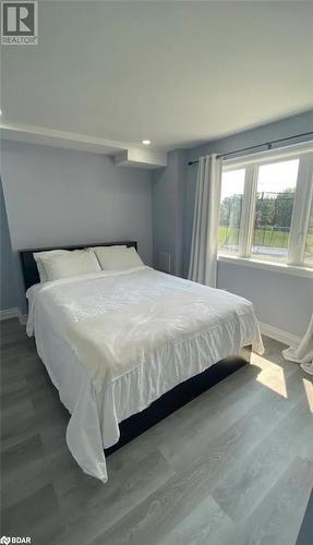 Bedroom featuring hardwood / wood-style flooring - 896 John Street Street Unit# B2, Innisfil, ON - Indoor Photo Showing Bedroom