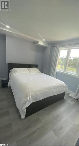 Bedroom featuring wood-type flooring - 896 John Street Street Unit# B2, Innisfil, ON - Indoor Photo Showing Bedroom