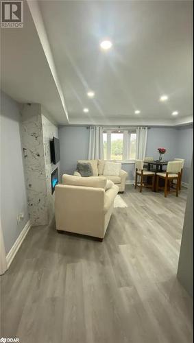 Living room featuring light wood-type flooring - 896 John Street Street Unit# B2, Innisfil, ON - Indoor