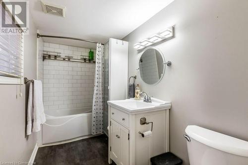 Full bathroom with vanity, shower / bathtub combination with curtain, and toilet - 9 Adam Street, Cambridge, ON 