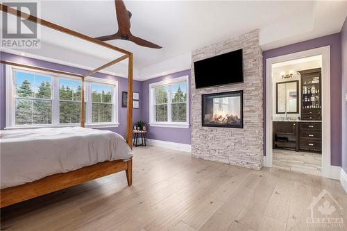 10385 Shaw Road, Mountain, ON - Indoor Photo Showing Bedroom With Fireplace