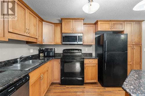 A207 103 Wellman Crescent, Saskatoon, SK - Indoor Photo Showing Kitchen With Double Sink