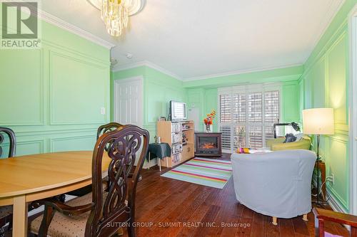 409 - 3880 Duke Of York Boulevard, Mississauga, ON - Indoor Photo Showing Dining Room With Fireplace