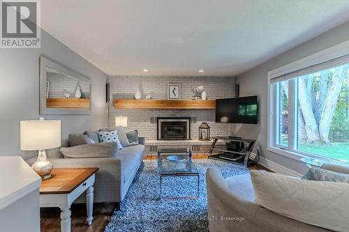 48 Lawrence Avenue, Springwater, ON - Indoor Photo Showing Living Room With Fireplace