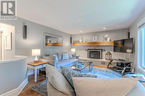 48 Lawrence Avenue, Springwater, ON - Indoor Photo Showing Living Room With Fireplace