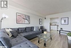 Living room featuring sink, a textured ceiling, and light wood-type flooring - 