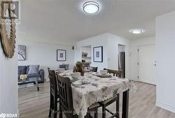 Dining space with light hardwood / wood-style floors and a textured ceiling - 