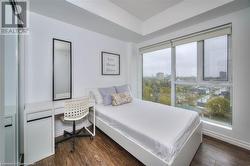 Bedroom featuring a closet and dark wood-type flooring - 