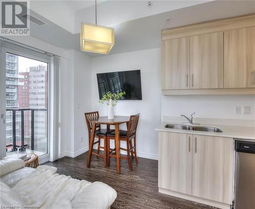 Dining area featuring sink and dark wood-type flooring - 160 King Street N Unit# 901, Waterloo, ON - Indoor