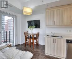 Dining area featuring sink and dark wood-type flooring - 