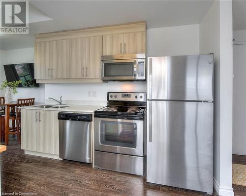 Kitchen featuring sink, light brown cabinetry, dark hardwood / wood-style floors, and appliances with stainless steel finishes - 160 King Street N Unit# 901, Waterloo, ON - Indoor Photo Showing Kitchen With Stainless Steel Kitchen With Double Sink