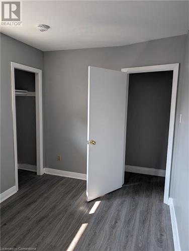 Unfurnished bedroom with dark wood-type flooring - 175 Oxford Street Unit# A, Kitchener, ON - Indoor Photo Showing Other Room