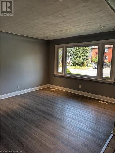 Unfurnished room with dark hardwood / wood-style floors - 175 Oxford Street Unit# A, Kitchener, ON - Indoor Photo Showing Other Room