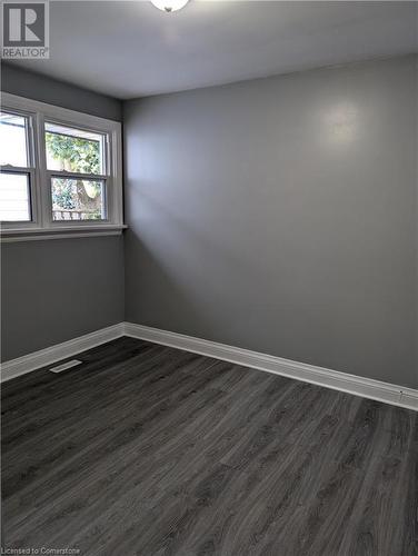 Empty room featuring dark hardwood / wood-style flooring - 175 Oxford Street Unit# A, Kitchener, ON - Indoor Photo Showing Other Room