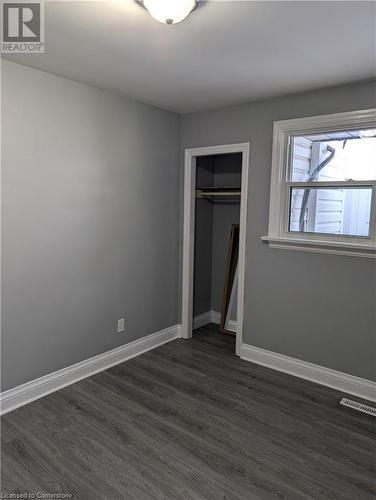 Unfurnished bedroom with dark hardwood / wood-style flooring and a closet - 175 Oxford Street Unit# A, Kitchener, ON - Indoor Photo Showing Other Room