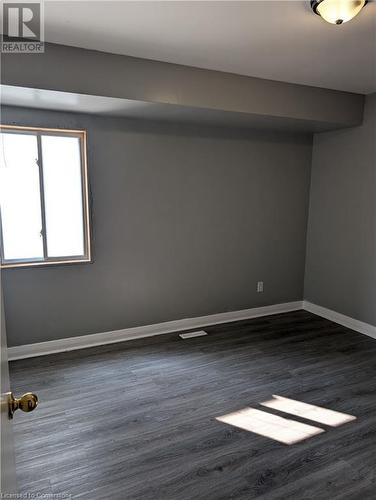 Spare room with dark hardwood / wood-style flooring - 175 Oxford Street Unit# A, Kitchener, ON - Indoor Photo Showing Other Room