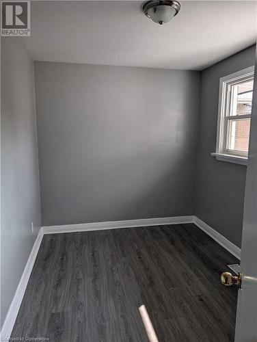 Unfurnished room featuring dark hardwood / wood-style floors - 175 Oxford Street Unit# A, Kitchener, ON - Indoor Photo Showing Other Room