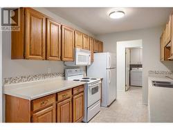 The first thing you will notice is an immaculate kitchen with pristine appliances & oak wood cabinetry - 