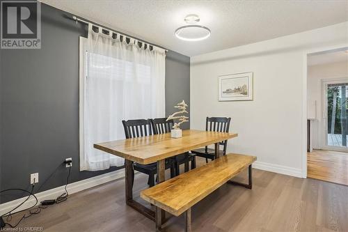 Dining area featuring hardwood / wood-style floors and a textured ceiling - 5021 Bunton Crescent, Burlington, ON - Indoor Photo Showing Dining Room