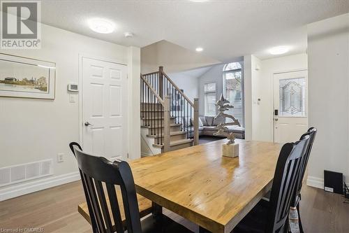 Dining space featuring a textured ceiling and hardwood / wood-style flooring - 5021 Bunton Crescent, Burlington, ON - Indoor Photo Showing Dining Room