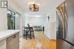 Kitchen with light hardwood / wood-style floors and stainless steel appliances - 