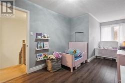 Bedroom with dark hardwood / wood-style flooring and a textured ceiling - 