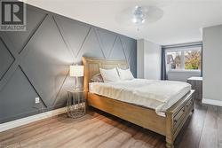 Bedroom featuring ceiling fan and light hardwood / wood-style floors - 