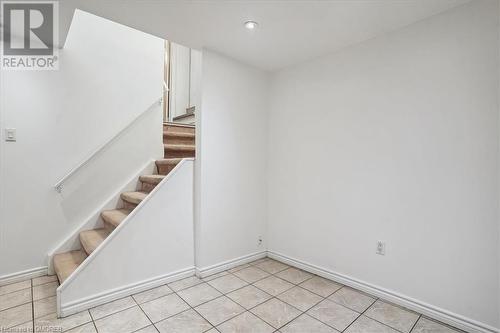 Staircase with tile patterned flooring - 5021 Bunton Crescent, Burlington, ON - Indoor Photo Showing Other Room